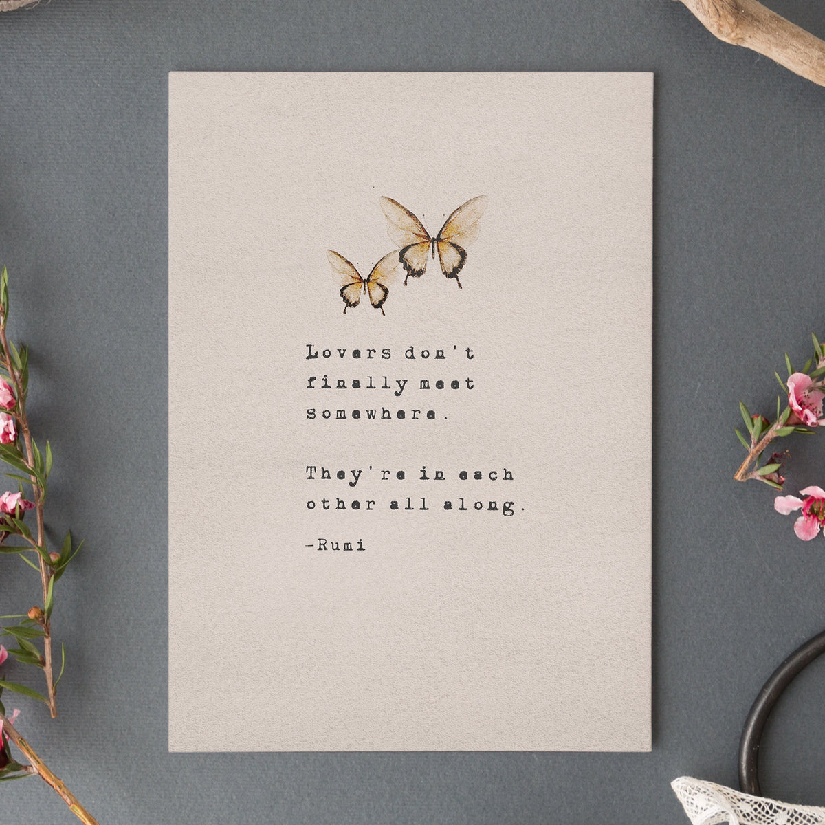 A typographic art print featuring the quote 'Love is friendship set to music.' on musical staff lines, with a small blue-gray floral illustration in the lower left and the text '-Jackson Pollock' near the bottom.