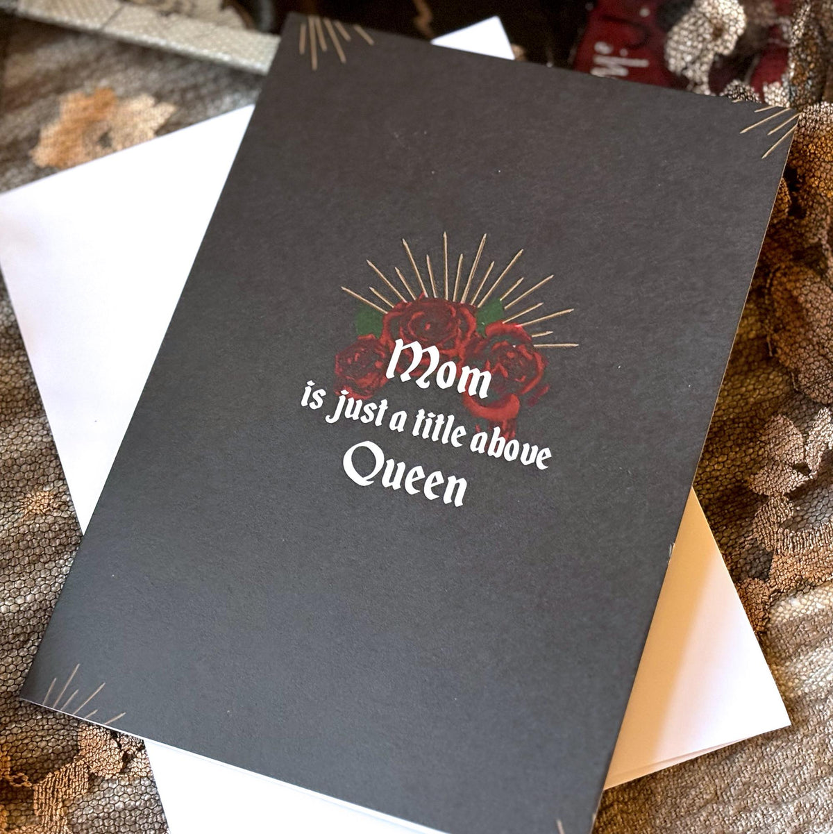A black mother's day card with the text 'Mom is just a little above Queen'