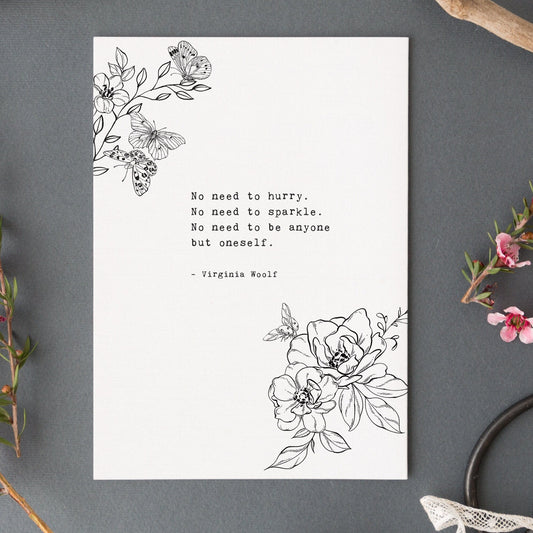 A vertical white art print black floral line art in the top left and bottom right corners, plus a centered quote from Virginia Woolf reading 'No need to hurry. No need to sparkle. No Need to be anyone by oneself
