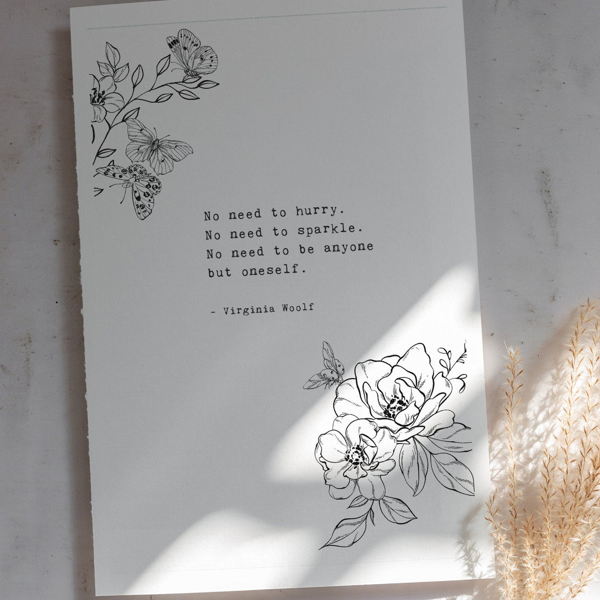 A vertical white art print black floral line art in the top left and bottom right corners, plus a centered quote from Virginia Woolf reading 'No need to hurry. No need to sparkle. No Need to be anyone by oneself