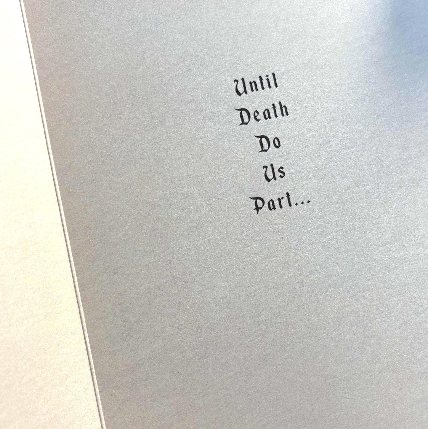A close-up of inside of greeting card with printed phrase 'Until Death Do Us Part.