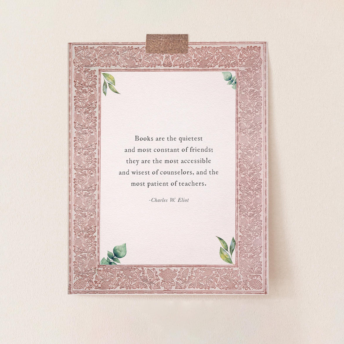 An unframed quote print featuring a Charles Eliot quote about books, with a dusty rose ornate border and the quote "Books are the quietest and most constant of friends"