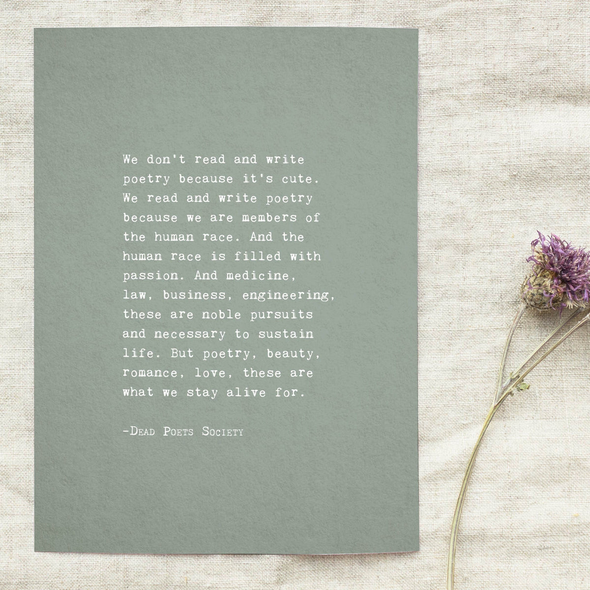A vertical art print with a muted sage green background and white text featuring a quote by Dead Poets Society "we don't read and write poetry because it's cute" full quote