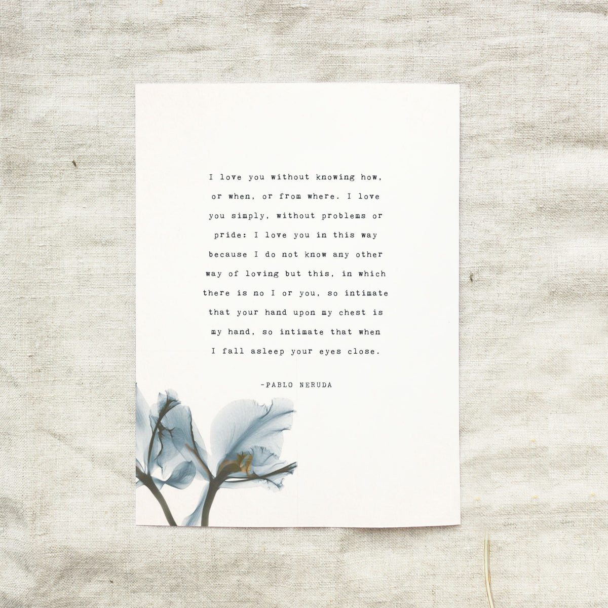 A vertical white art print featuring a quote by Pablo Neruda "I love you without knowing how, or when, or from where." in typewriter font and a blue watercolor floral illustration at the bottom. 