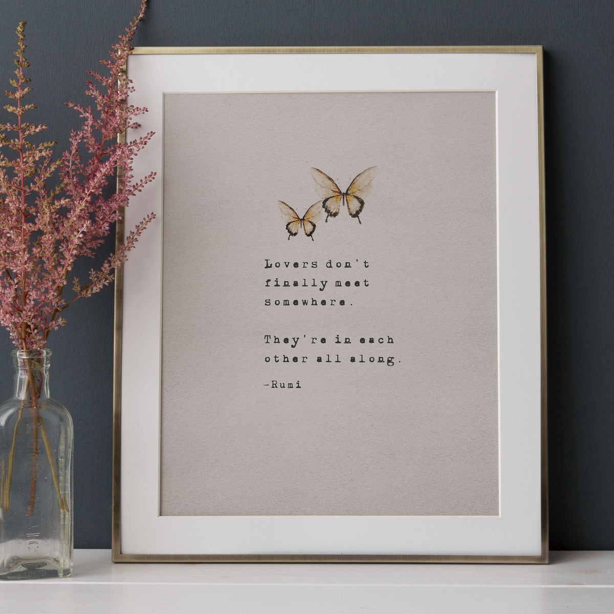 A typographic art print featuring the quote 'Love is friendship set to music.' on musical staff lines, with a small blue-gray floral illustration in the lower left and the text '-Jackson Pollock' near the bottom.
