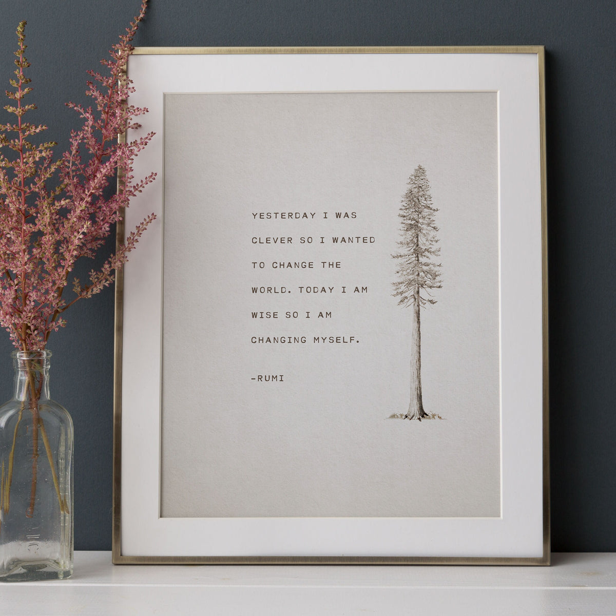 An art print feature an illustration of a pine tree and a quote that says "Yesterday I was clever so I wanted to change the world. Today I am wise so I am changing myself"-Rumi