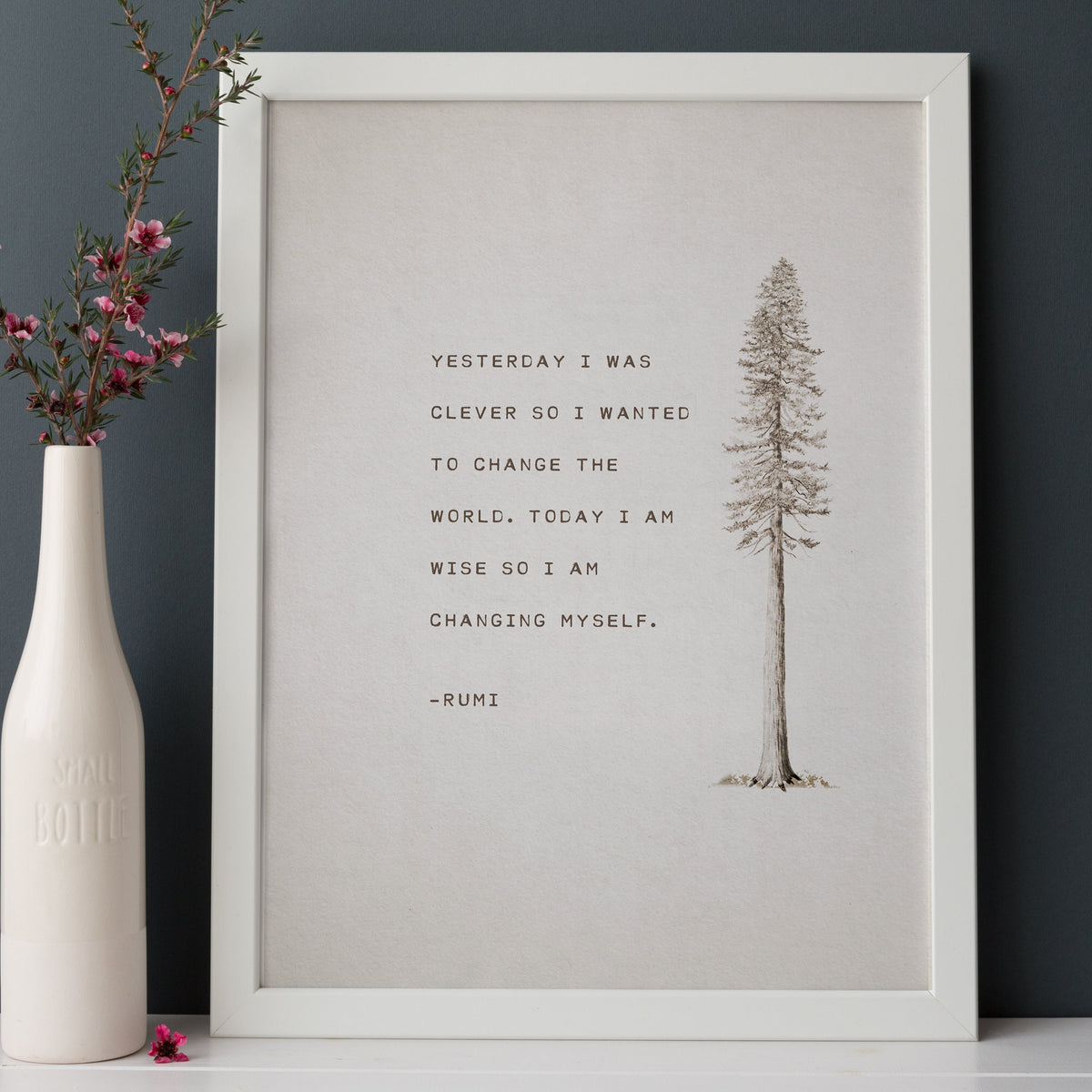 An art print feature an illustration of a pine tree and a quote that says "Yesterday I was clever so I wanted to change the world. Today I am wise so I am changing myself"-Rumi