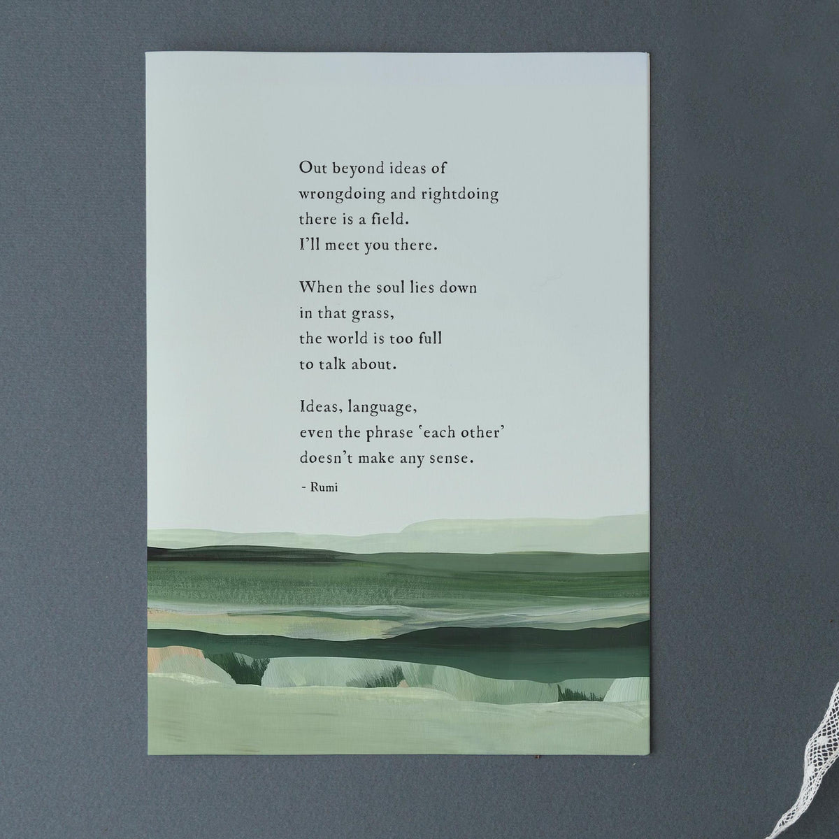 A framed art print featuring a quote by Rumi over a minimalist landscape painting in shades of green and gray with a quote by Rumi that says "out beyond the ideas of wrongdoing and right doing there is a field. I'll meet you there"