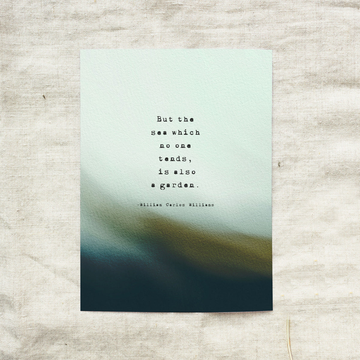 A vertical art print featuring a quote by William Carlos Williams, 'But the sea which no one tends, is also a garden.' The print has a textured light blue and teal top half fading into a dark teal and olive bottom half