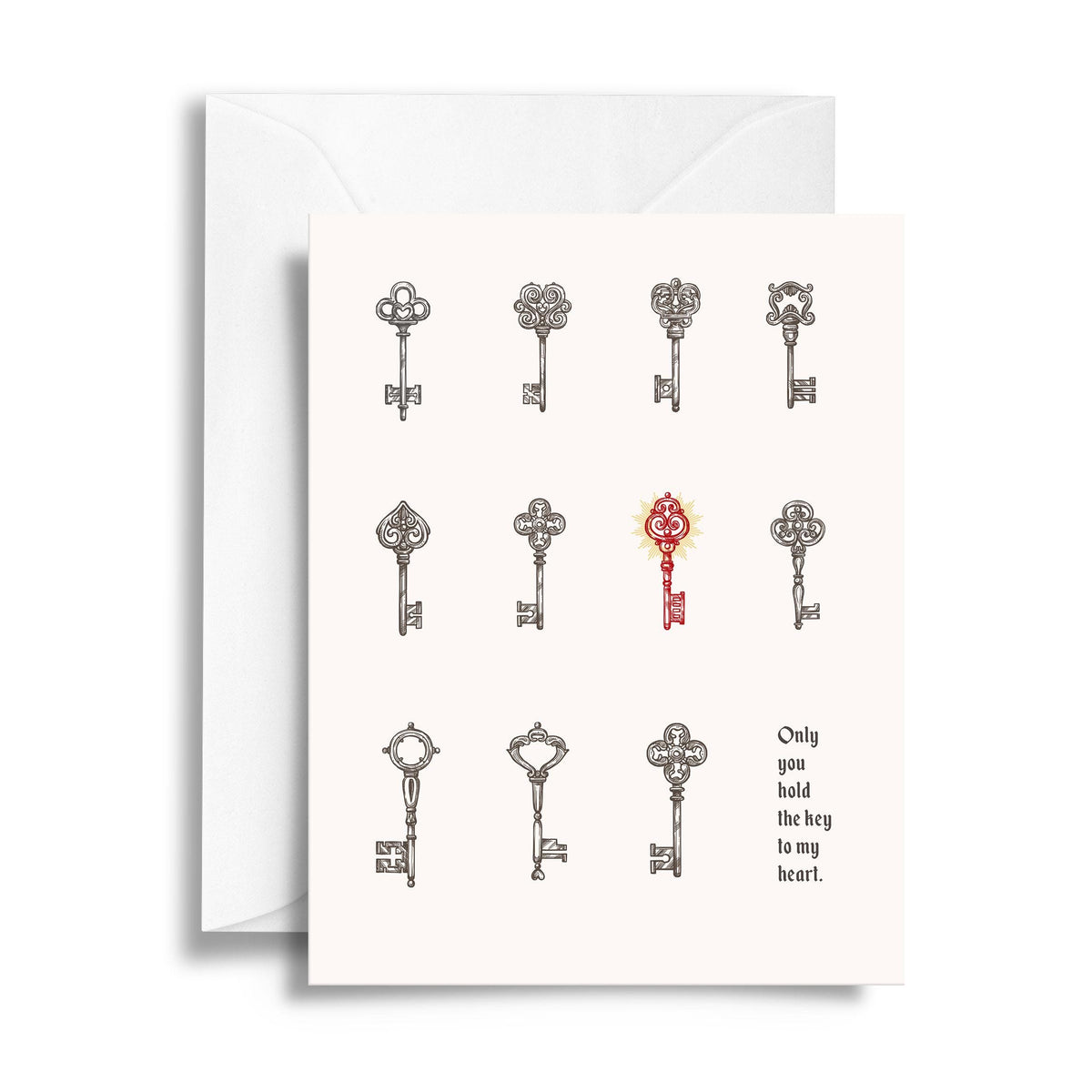 A white greeting card featuring illustrated vintage keys, with one red key in the center and the printed phrase 'Only you hold the key to my heart.' 