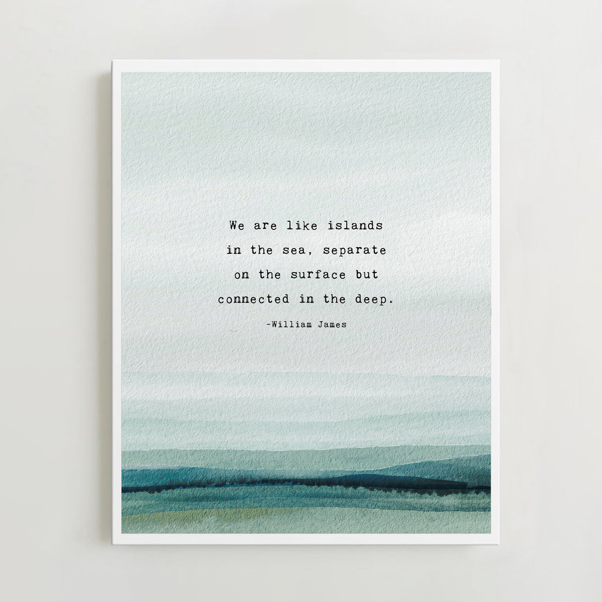A vertical art print featuring a watercolor ocean scene in soft blue, teal, and green tones, with a quote by William James centered on the front which says "we are like islands in the sea, separate on the surface but connected in the deep".