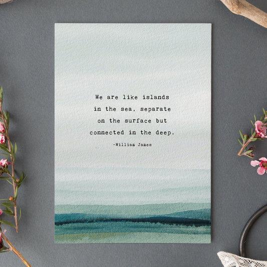 A vertical art print featuring a watercolor ocean scene in soft blue, teal, and green tones, with a quote by William James centered on the front which says "we are like islands in the sea, separate on the surface but connected in the deep".