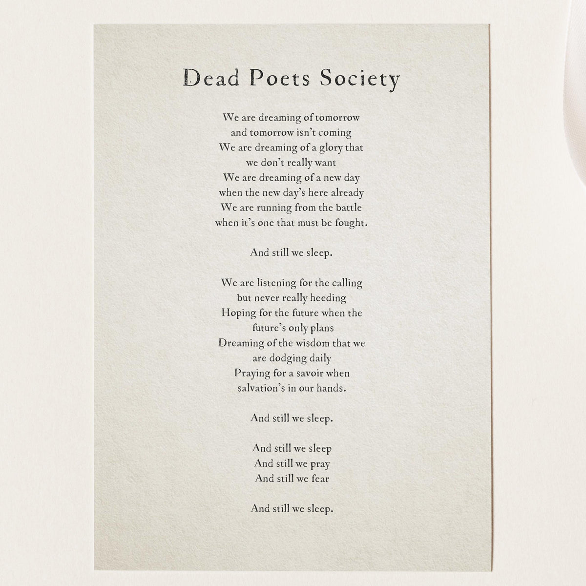 A simple wall art print featuring a quote from the movie 'Dead Poets Society'  that says "we are dreaming of tomorrow and tomorrow isn't coming. We're dreaming of a gloy that we don't really want..."