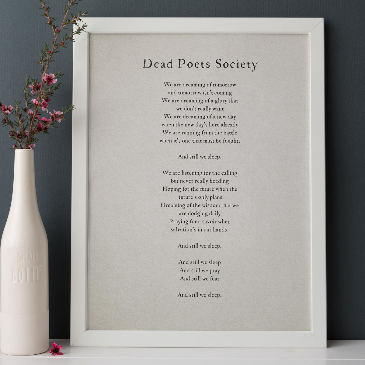 A simple wall art print featuring a quote from the movie 'Dead Poets Society'  that says "we are dreaming of tomorrow and tomorrow isn't coming. We're dreaming of a gloy that we don't really want..."