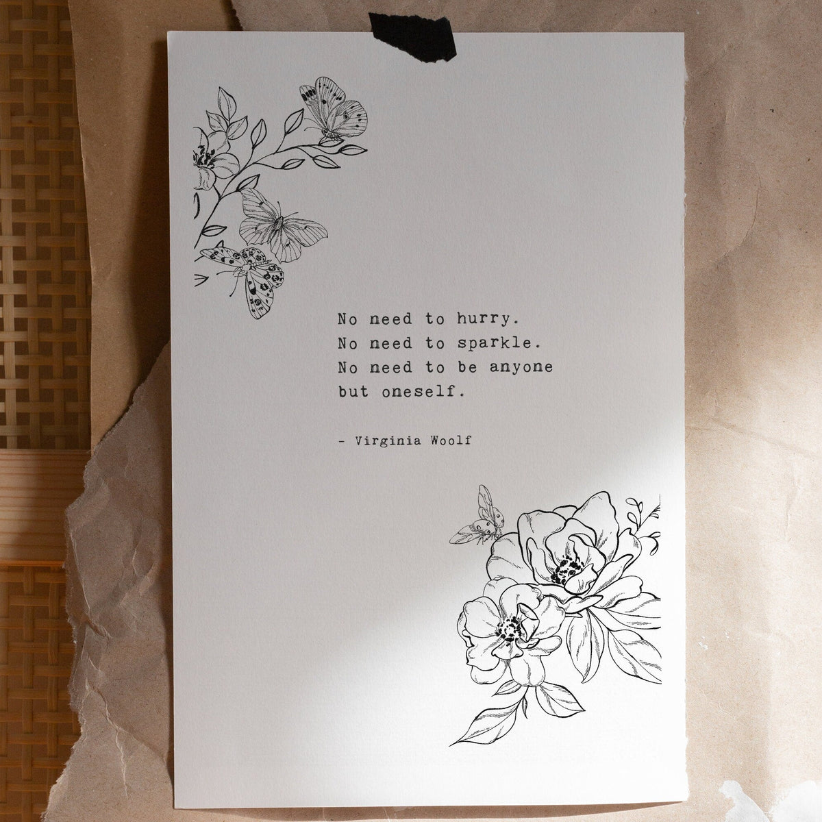 A vertical white art print black floral line art in the top left and bottom right corners, plus a centered quote from Virginia Woolf reading 'No need to hurry. No need to sparkle. No Need to be anyone by oneself
