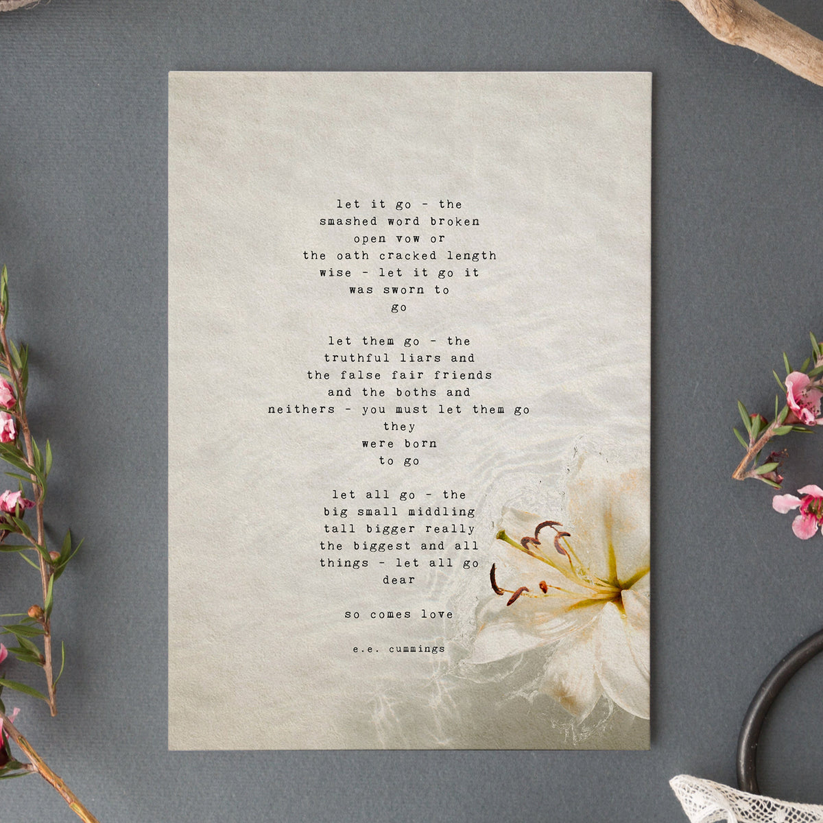 An art print featuring a typewriter-style poem by e.e. cummings on a textured beige background with a white flower illustration in the lower right corner