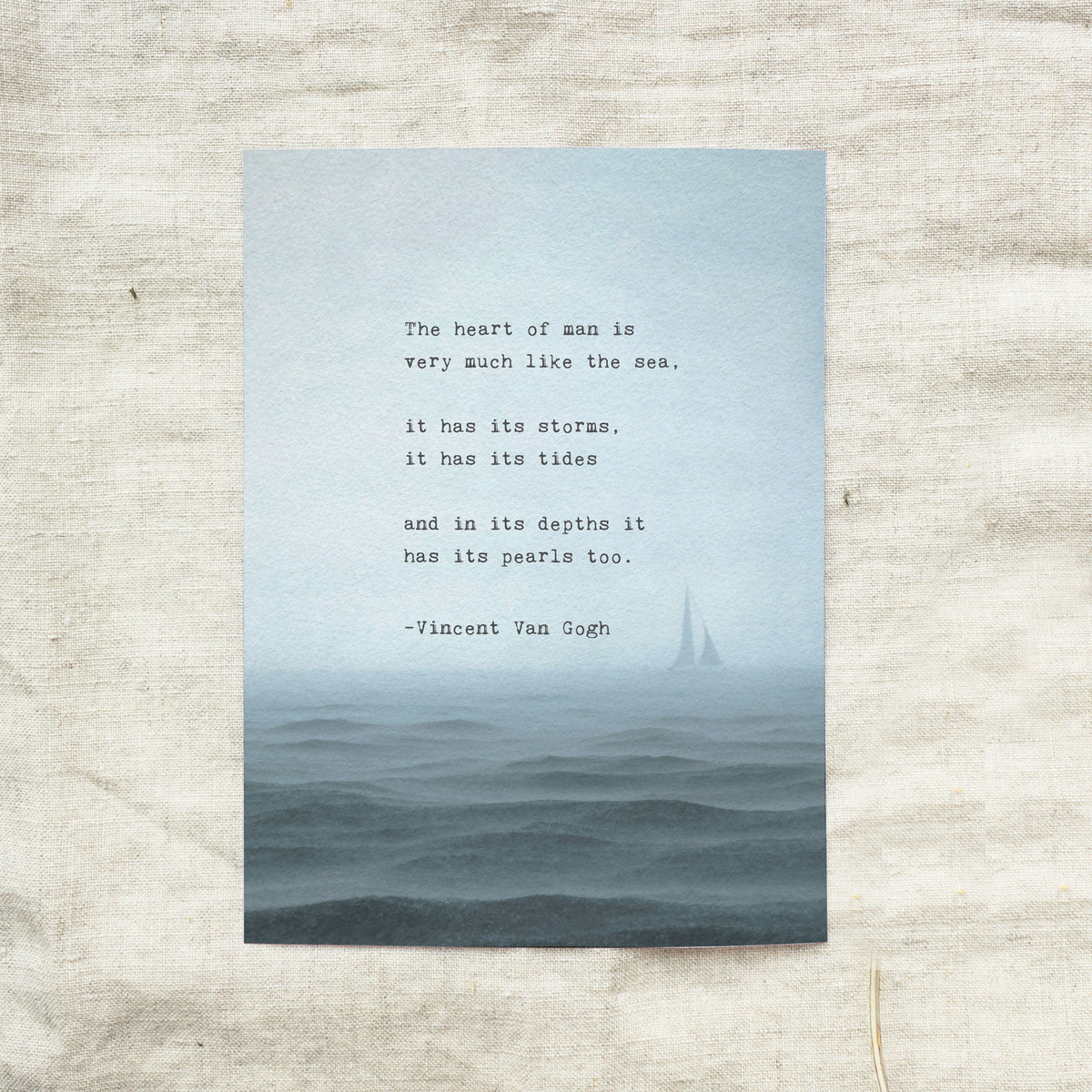 An art print featuring a quote by Vincent Van Gogh about the sea, set against a misty blue ocean scene with a small sailboat. The quote says "the heart of man is very much like the sea, it has its storms it has its tides and in its depths it has its pearls too"