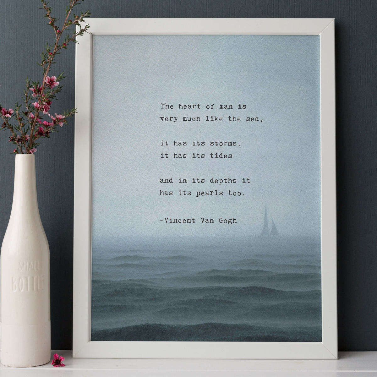 An art print featuring a quote by Vincent Van Gogh about the sea, set against a misty blue ocean scene with a small sailboat. The quote says "the heart of man is very much like the sea, it has its storms it has its tides and in its depths it has its pearls too"