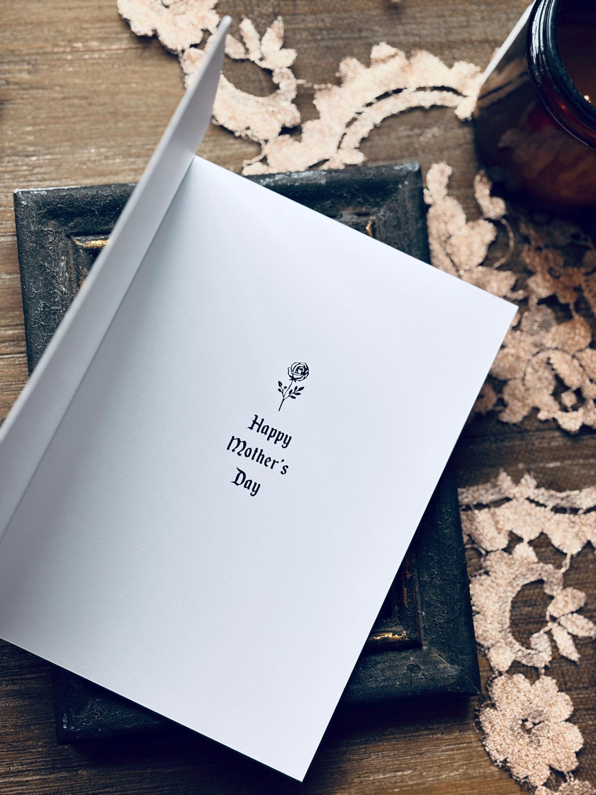 Inside of mother's day card that says "Happy mothers day" with a rose graphic
