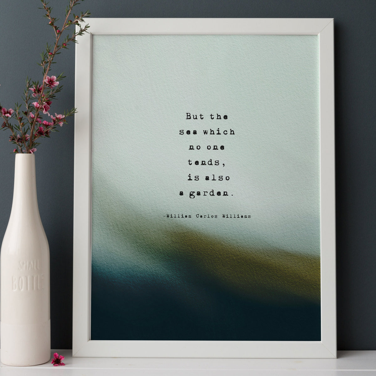 A vertical art print featuring a quote by William Carlos Williams, 'But the sea which no one tends, is also a garden.' The print has a textured light blue and teal top half fading into a dark teal and olive bottom half