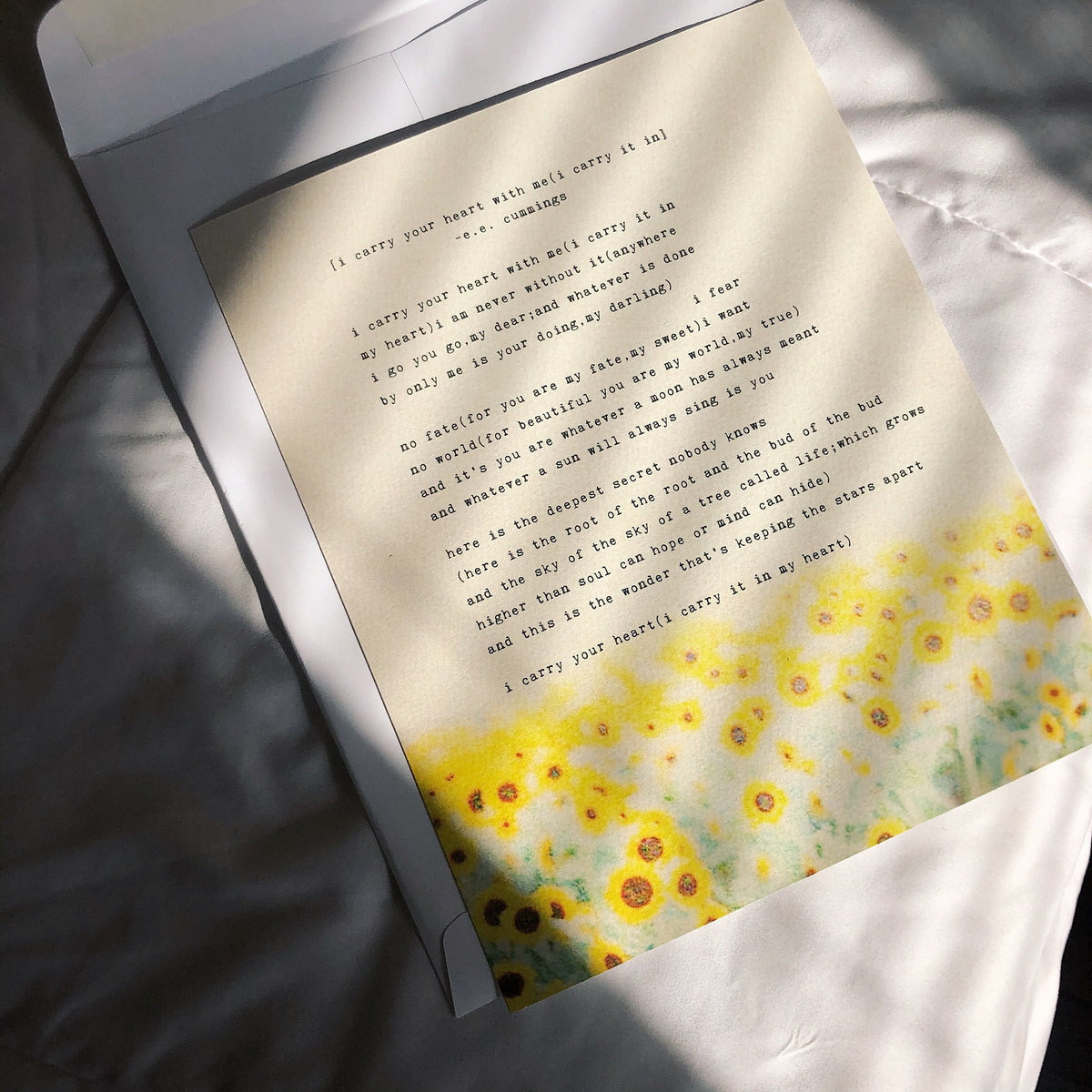 An art print of sunflowers with the poem by e.e. cummings "I carry your heart with me(I carry it in}