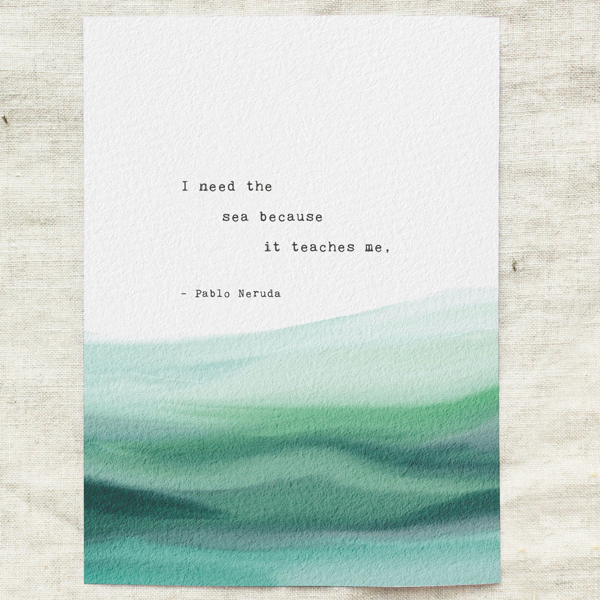 A typographic art print featuring a quote by Pablo Neruda over a watercolor ocean wave design in shades of teal. It says "I need the sea because it teaches me"