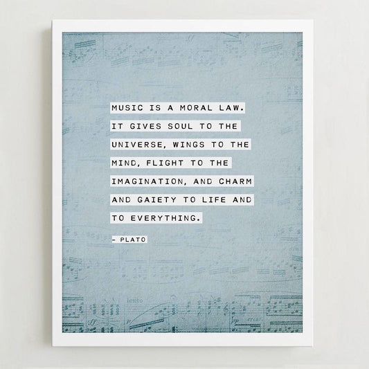 An art print of sheet music on a pale blue background with the quote by Plato "Music is a moral law, it gives soul to the universe, wings to the mind..."