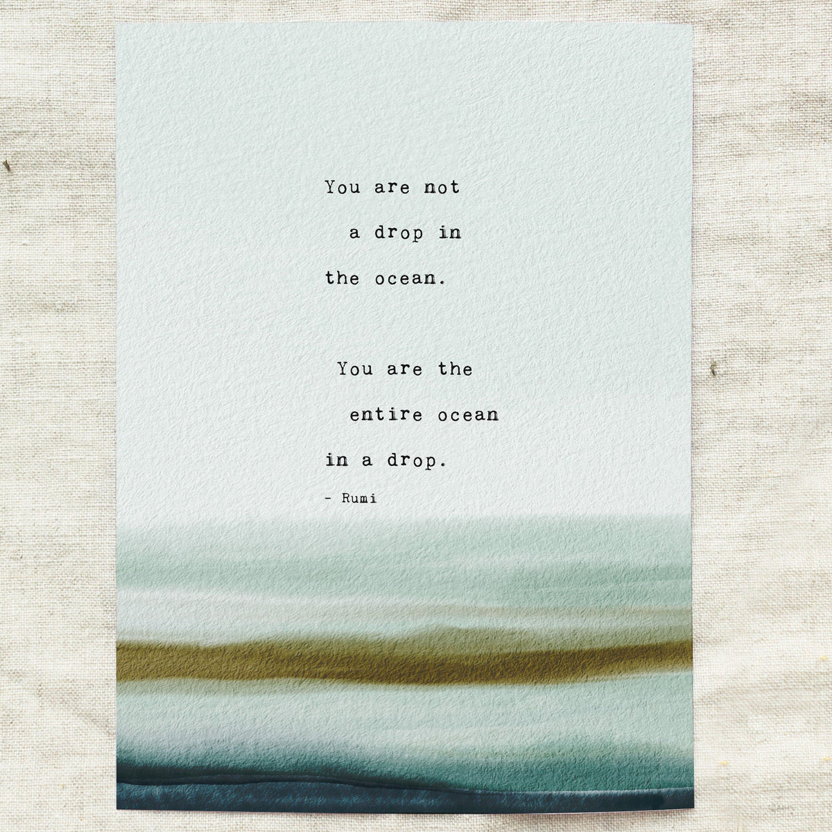 A typographic art print featuring a quote by Rumi over a watercolor ocean wave design in shades of teal and green. The quote says "you are not a drop in the ocean, you are the entire ocean in a drop"